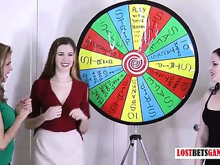 3 très jolies filles jouent à un jeu de stripe faire tourner wheezles roue